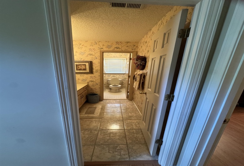 Tiled flooring extending throughout a dedicated bathroom space