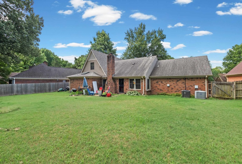 Expansive backyard featuring a lush green lawn