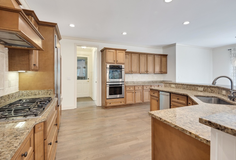 Features GE Monogram 5-burner gas cooktop, double convection ovens, microwave, icemaker, and frig/frzr plus a Bosch dishwasher.