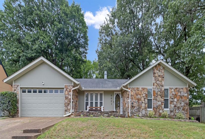 Exterior featuring a stone facade and light-colored siding