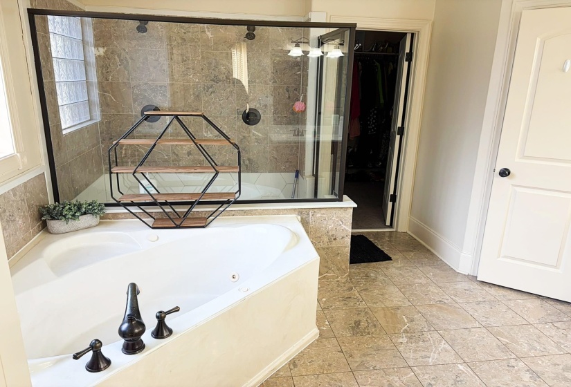 Corner soaking tub featuring oil-rubbed bronze fixtures