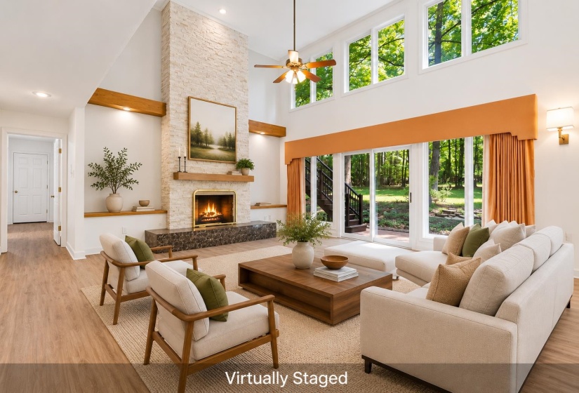 Vaulted living area featuring a stacked stone fireplace with a wood mantle and marble hearth