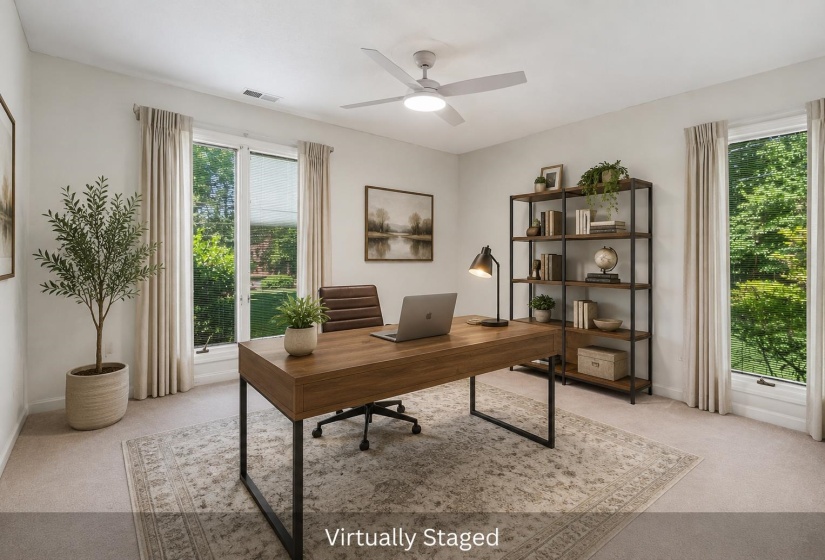 Bright room featuring light-toned carpeting and multiple large windows