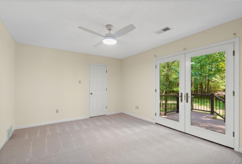 Spacious room with light-toned carpeting and neutral wall paint