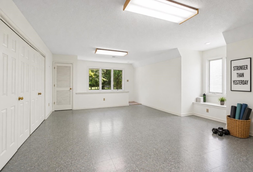 Spacious room with light gray flooring and white walls