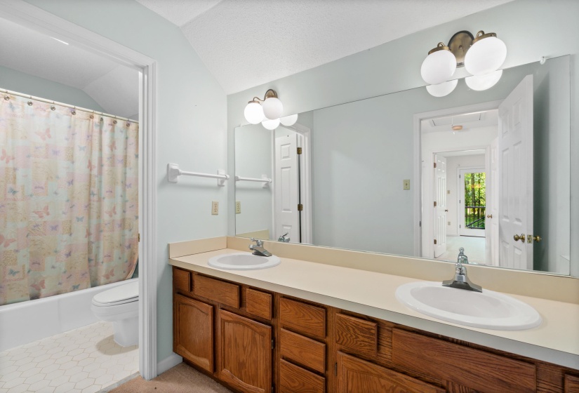 Dual vanity with wood-finish cabinetry and integrated sinks