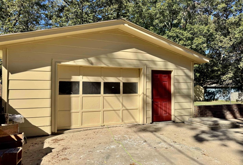 Garage featuring concrete driveway