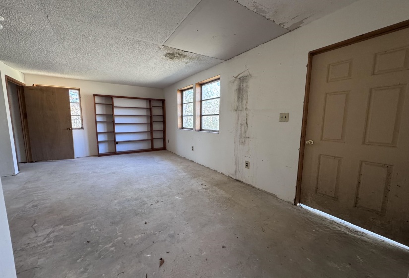 Spare room featuring concrete flooring and a textured ceiling