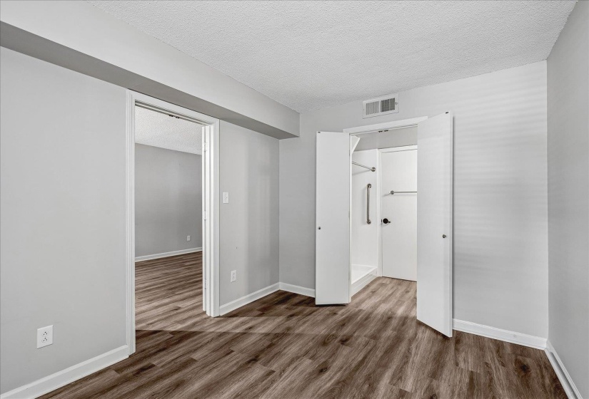 Interior room featuring wood-finish flooring and light gray walls