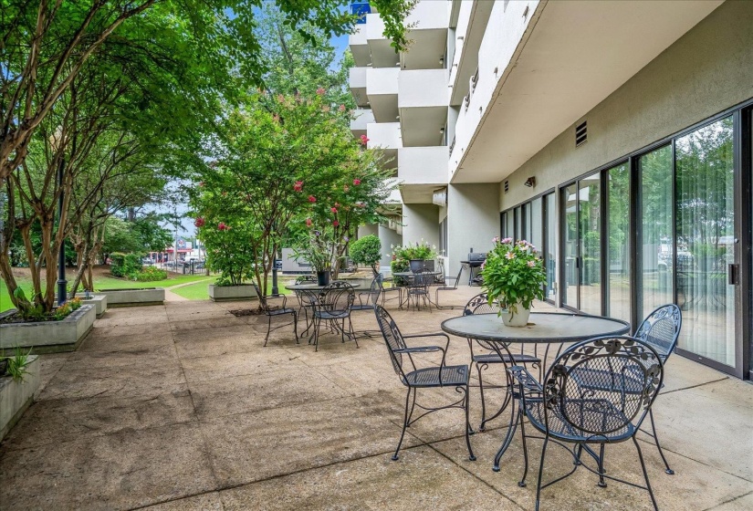 Spacious concrete patio with multiple sliding glass door entries