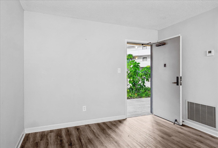Entryway featuring wood-finish flooring, white baseboards, and light gray walls