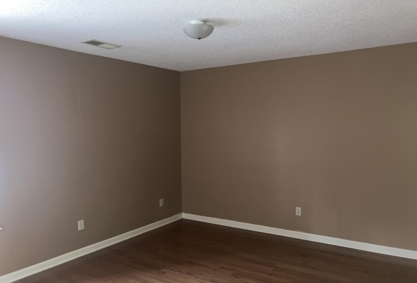 Room with neutral wall paint and wood-finish flooring