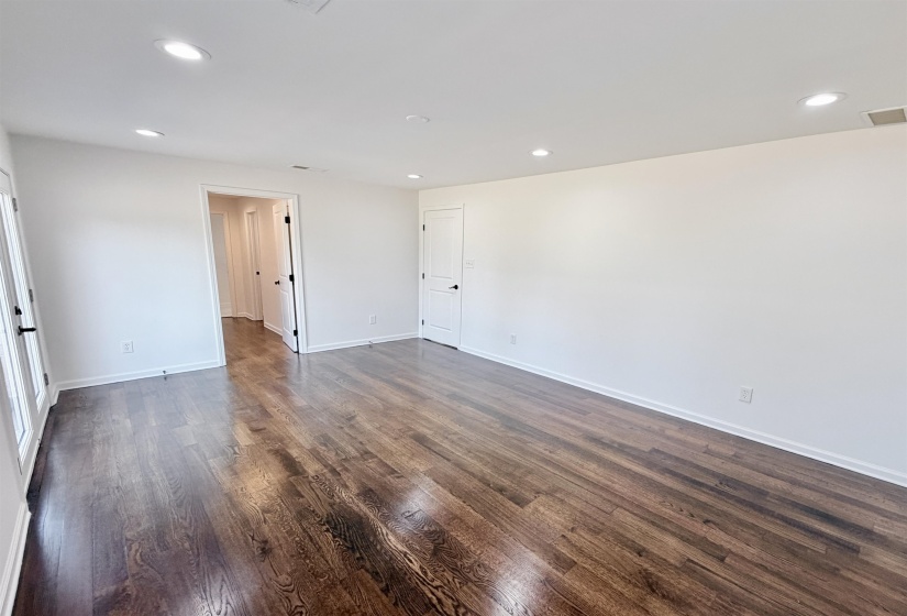 Unfurnished bedroom with recessed lighting and dark hardwood floors