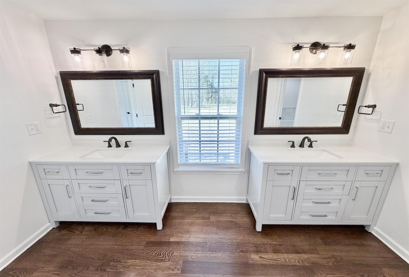 Bathroom featuring two soft close vanities and dark hardwood floors