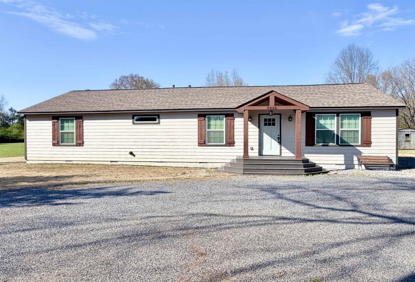 View of front of house with roof with shingles, crawl space, and a porch