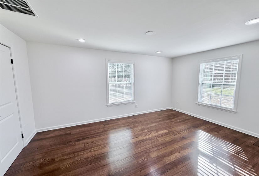 Unfurnished room with dark hardwood floors, a large closet, and recessed lighting