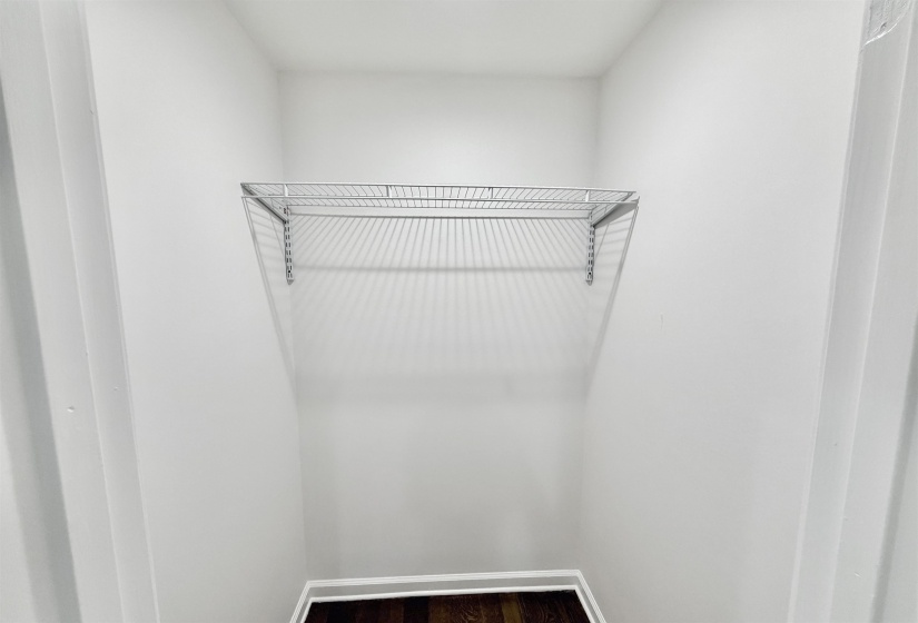 Walk in closet featuring dark wood-style floors and recessed lighting.