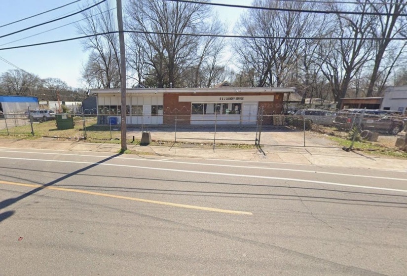 View of front of house with a fenced front yard and driveway