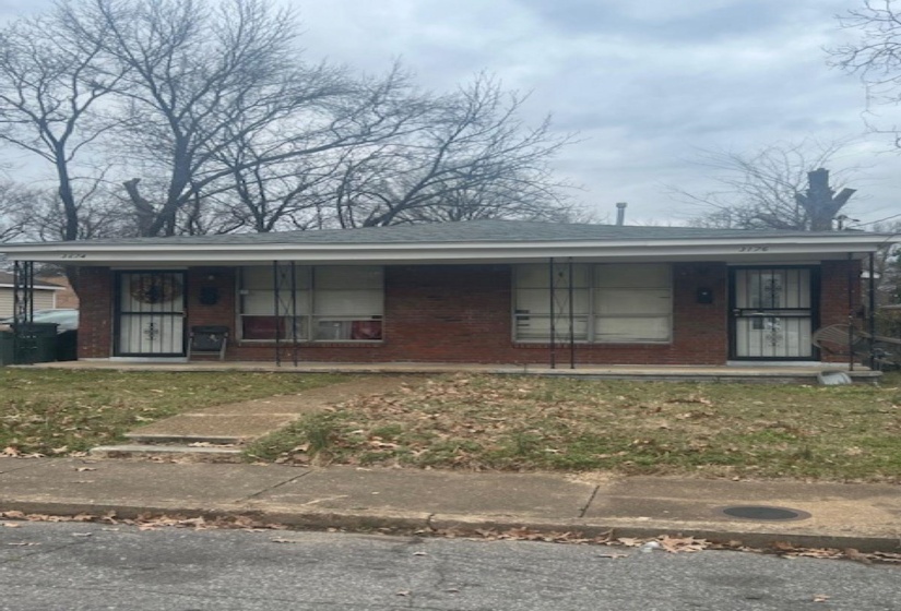 View of front of property with a porch and brick siding