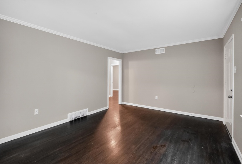 Spacious interior room with dark wood-finish flooring