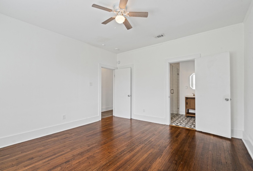 Wood-finish flooring throughout, featuring a ceiling fan with integrated lighting