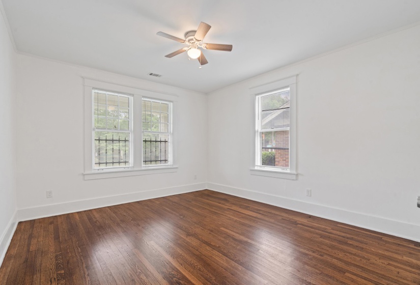 Hardwood flooring throughout, featuring a ceiling fan with integrated lighting