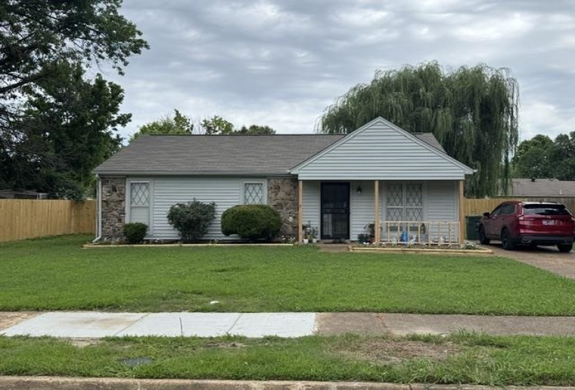 Exterior facade featuring light-colored siding and stone accents