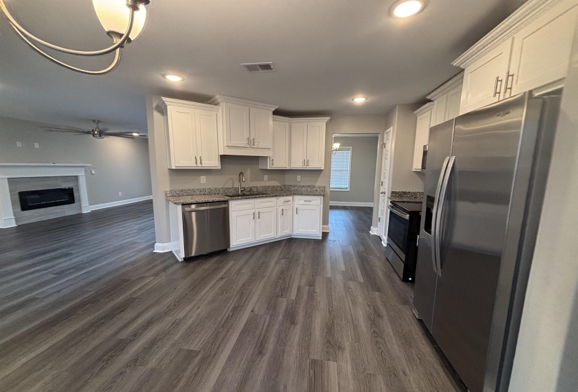 Kitchen featuring white cabinetry, granite countertops, and stainless steel appliances