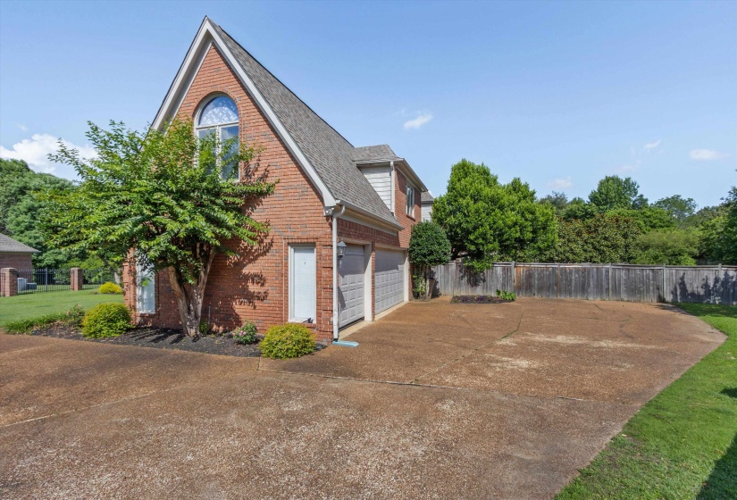Brick exterior featuring a gabled roofline and an arched window