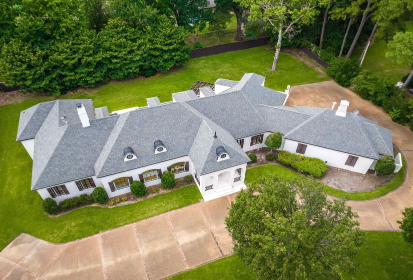 Expansive property featuring a multi-gabled roofline, multiple dormer windows, and a portico entry
