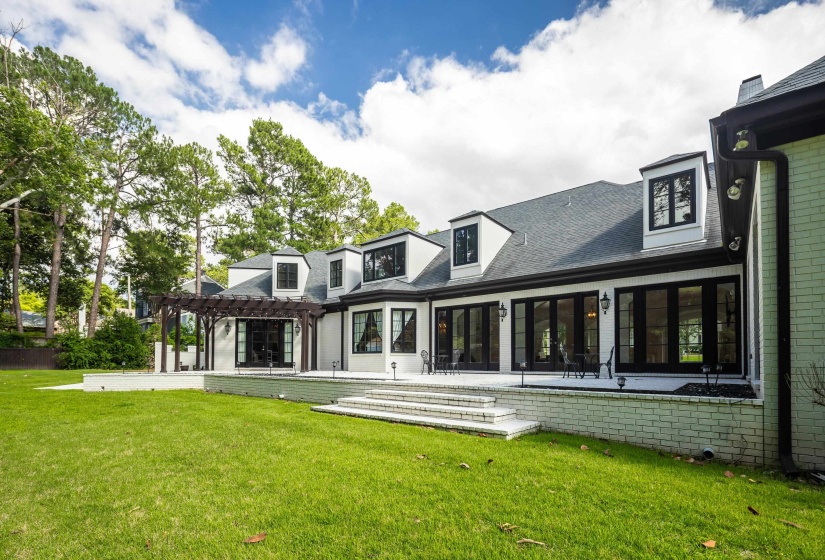 Expansive green lawn bordering a white brick exterior