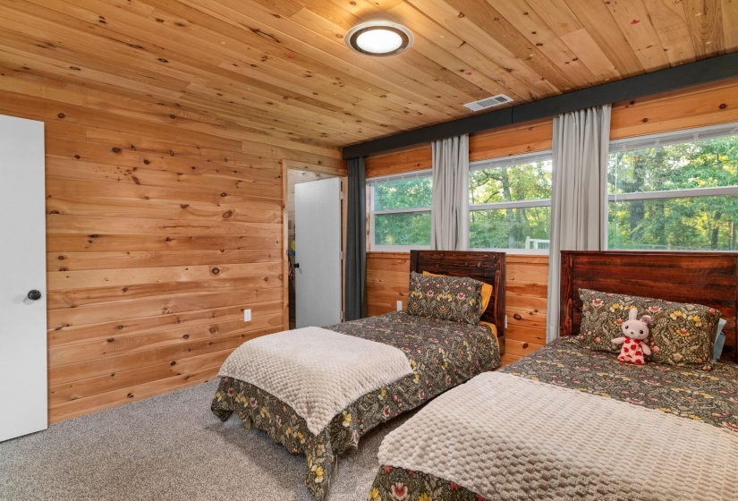 Wood-paneled walls and ceiling with recessed lighting