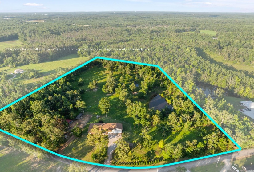 Expansive land parcel featuring a main residence, mature trees, open grassy areas, and a visible pond