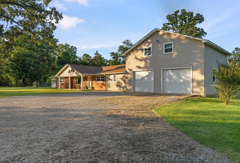 Exterior featuring a two-story attached garage with two overhead doors