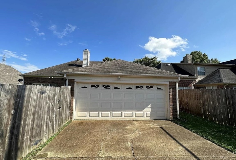 Attached two-car garage with decorative window inserts