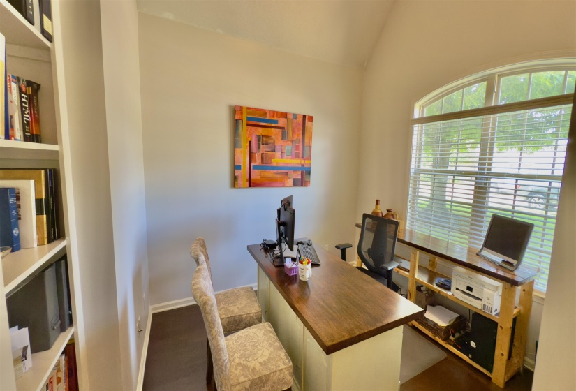 Office area with lofted ceiling and baseboards