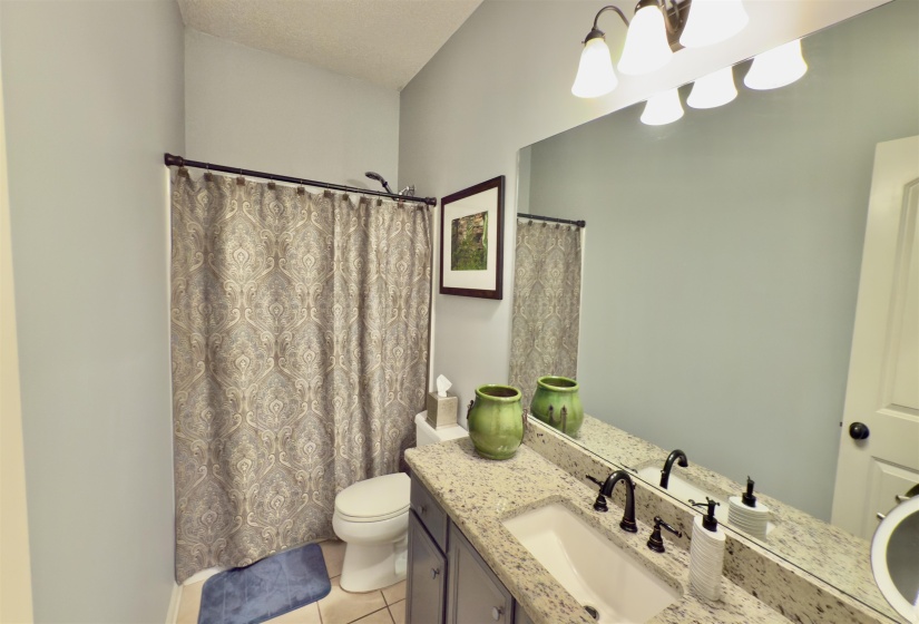Bathroom with vanity, tile patterned flooring, and a shower with curtain