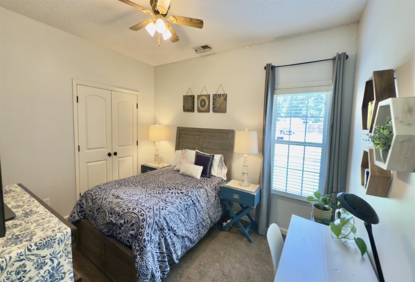 Bedroom featuring carpet floors, multiple windows, a closet, and ceiling fan