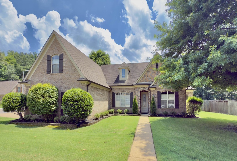 View of front of home featuring brick siding and stone siding