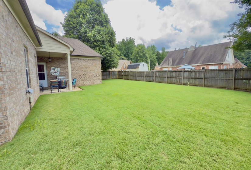 Fenced backyard with a patio