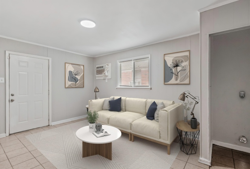 Living area featuring light-toned flooring, a front entry door with paneling, a rectangular window, and an overhead flush-mount light fixture