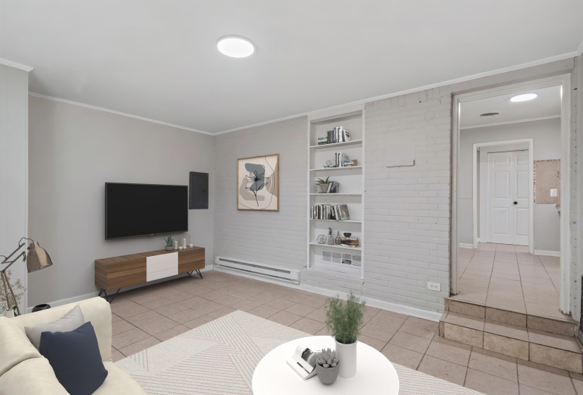 Living area featuring light gray walls, recessed lighting, tile flooring, and built-in shelving