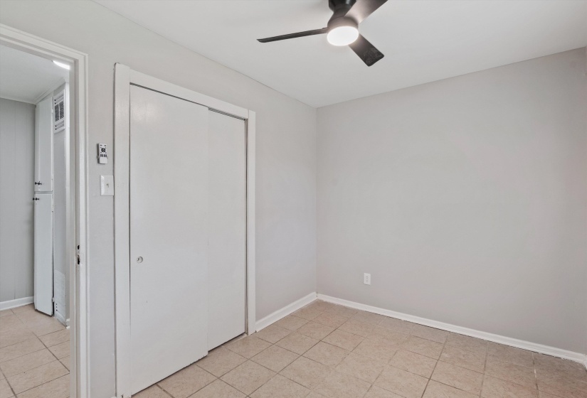 Room featuring neutral wall tones and square tile flooring
