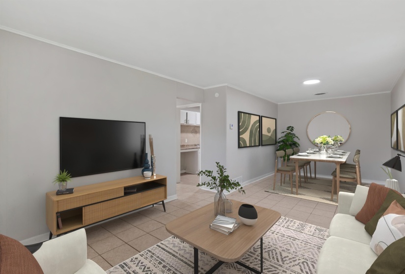 Open-concept living and dining area featuring light gray walls, tile flooring, and white baseboards