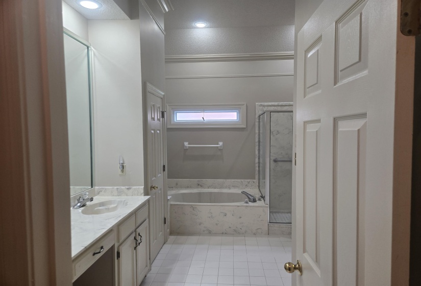 Bathroom featuring a dual-sink vanity with a light-colored countertop and integrated rectangular sinks