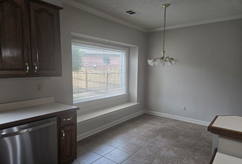 Dining area featuring a prominent window with a built-in window seat