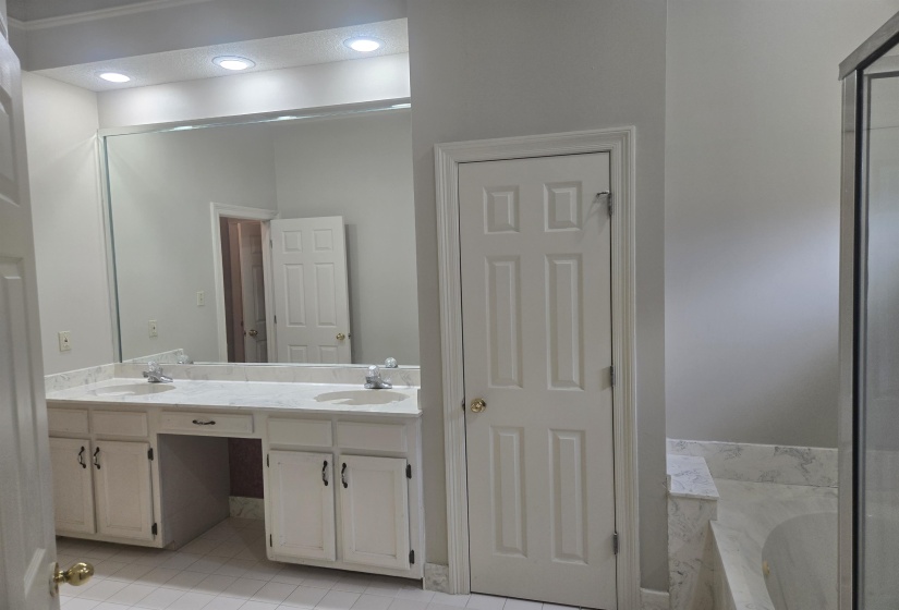 PRIMARY BATH Double vanity with white cabinetry, light-toned countertop, and dual sinks