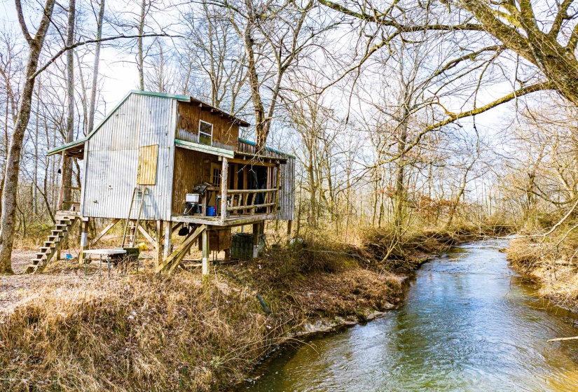 View of side of property featuring a water view and stairs