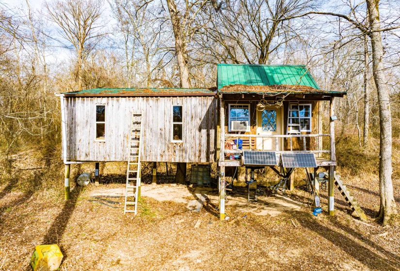 View of front of property with a metal roof and cooling unit