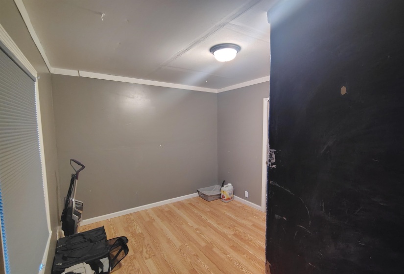Interior room featuring light wood-finish flooring and neutral-toned walls